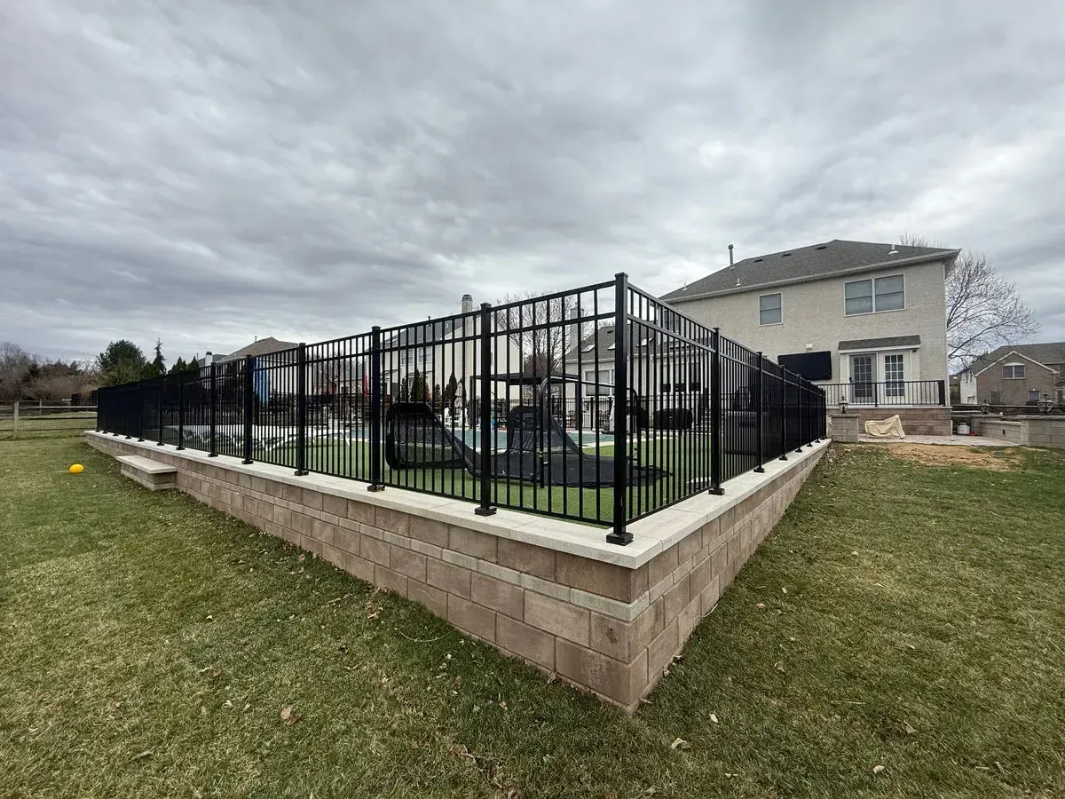 Pool retaining wall with aluminum safety fencing in Chester County PA