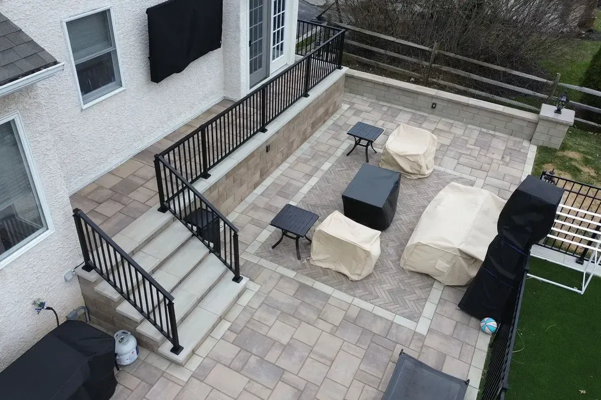 Techo-Bloc paver patio with herringbone inlay and aluminum railing Chester County PA