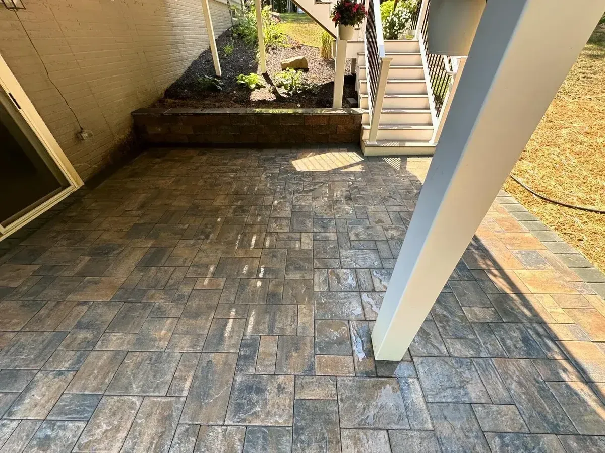 Sealed ashlar pattern paver patio with retaining wall planter in Chester County PA